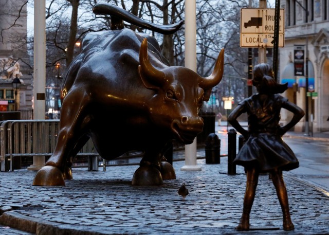 A statue of a girl facing the Wall St. Bull is seen in the financial district in New York